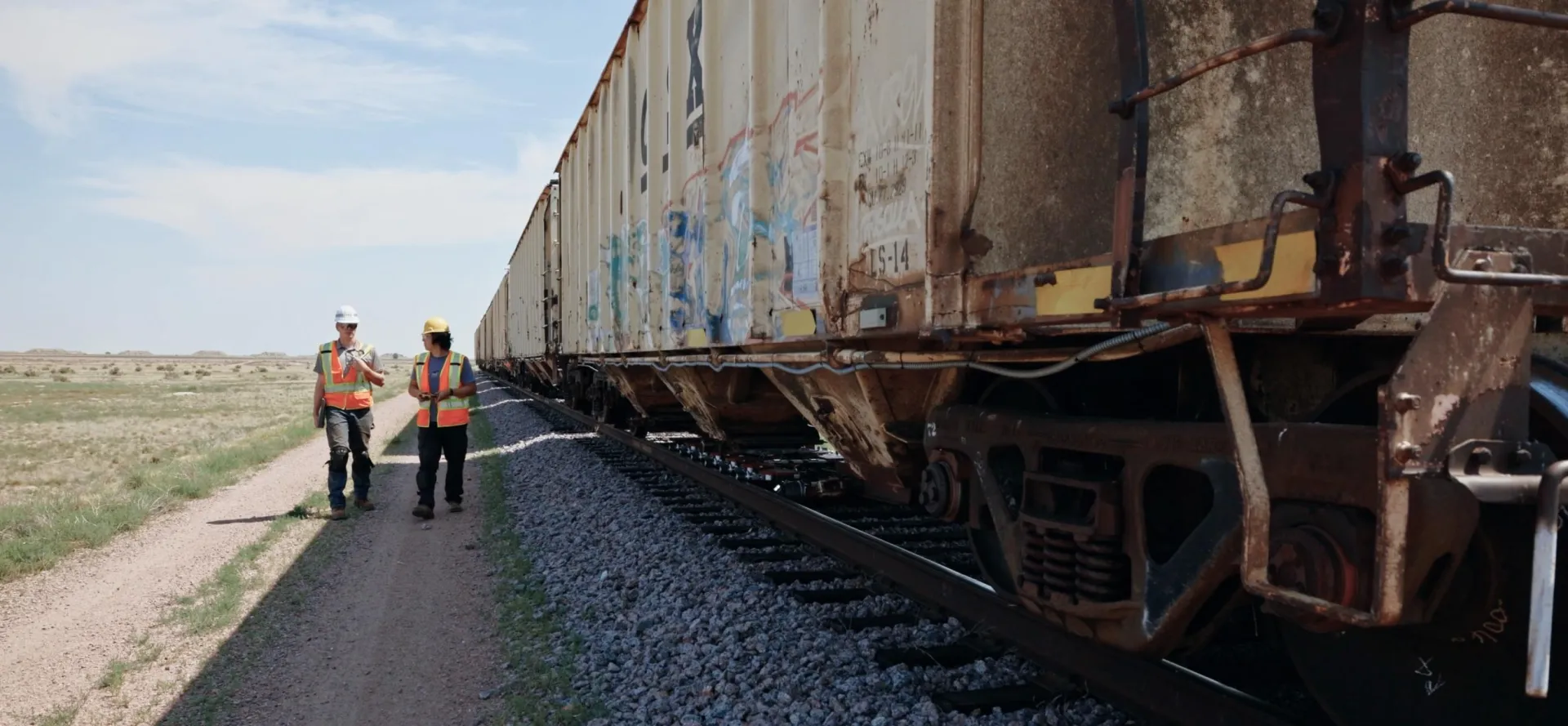 Forgeworks team walking alongside freight railcars