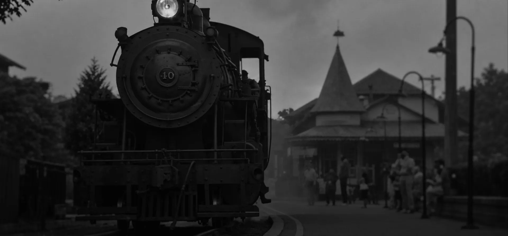 Historic steam locomotive at a train station